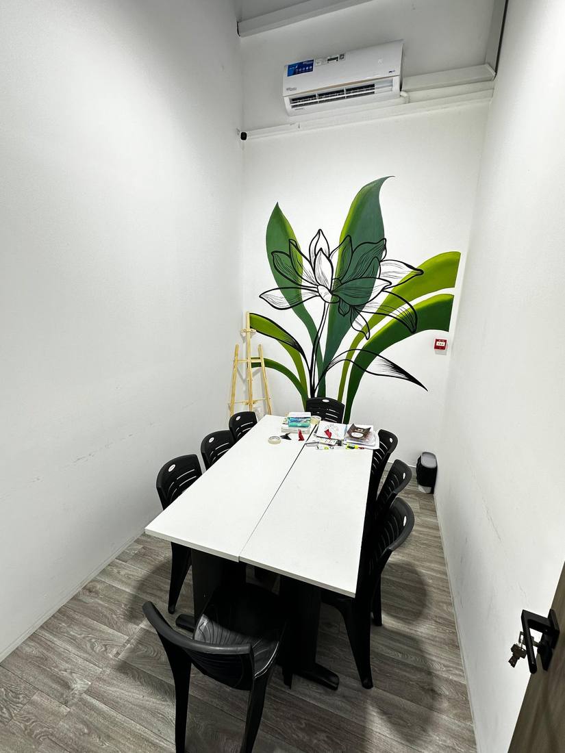Art room with a lotus mural and worktable for drawing and painting classes
