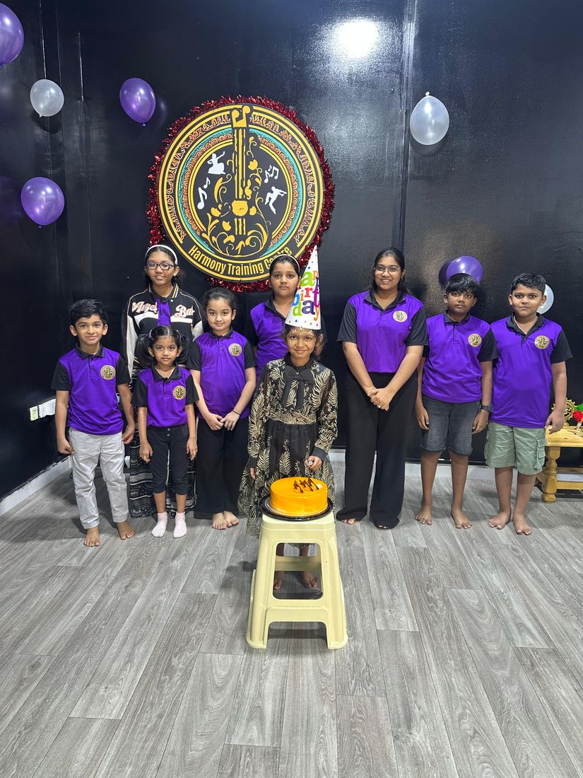 Students and instructor celebrating a birthday at the studio with a cake