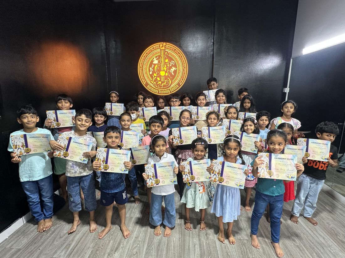 Group of students holding their Harmony Music camp completion certificates