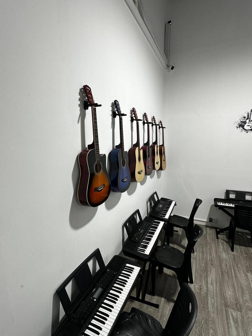 Acoustic guitars mounted on the wall at Harmony Music Training Centre