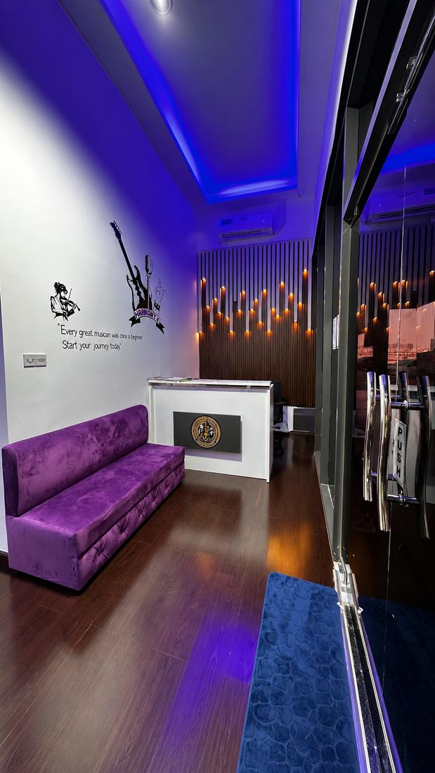 Reception area with the Harmony Music Training Centre logo and lounge seating